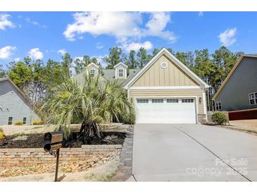 Charming single-Gathering home with a manicured lawn, palm tree, and an attached two-car garage at 5252 Admirals Lndg, Lancaster, SC 29720