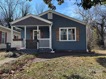 Charming single-story home featuring blue siding, a cozy front porch, and decorative wooden shutters at 827 W Horah St, Salisbury, NC 28144