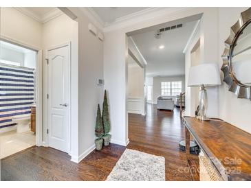 Bright entryway with wood floors, leading to the living spaces at 10014 Berkeley Castle Dr, Charlotte, NC 28273