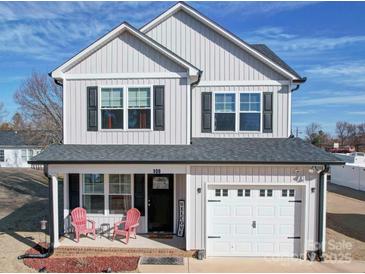 Charming two-story home with black shutters and a cozy front porch, offering a welcoming curb appeal at 108 Oak Grove St, Kannapolis, NC 28081