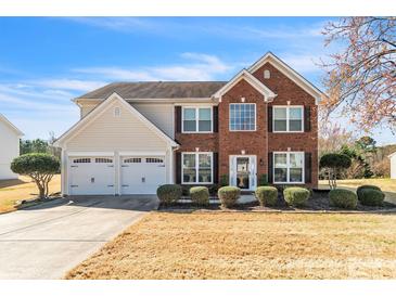 Charming two-story home with a brick facade, well-manicured landscaping, and a two-car garage at 279 Age Old Way, Rock Hill, SC 29732
