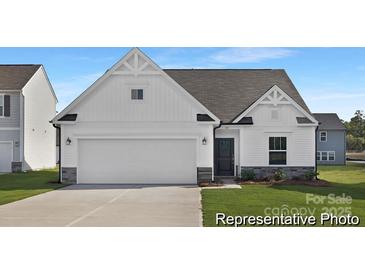 New construction home featuring a two-car garage, craftsman style accents, and a manicured lawn at 40189 Crooked Stick Dr # 1205, Lancaster, SC 29720