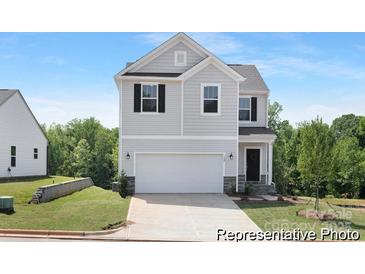 Two-story home with light gray siding, black shutters, and a two-car garage in a well-maintained community at 40189 Crooked Stick Dr # 1235, Lancaster, SC 29720