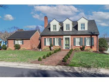 Charming brick home with dark shutters, dormer windows, and manicured front lawn, epitomizing curb appeal at 632 N Oakland Ave # Pt1, Statesville, NC 28677