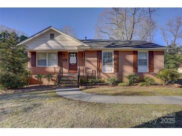 Charming brick home with manicured lawn and walkway leading to the front door at 7526 Dorn Cir, Charlotte, NC 28212