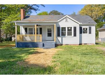 Charming one-story home with a cozy front porch and a well-maintained lawn at 112 Courtland St, Chester, SC 29706