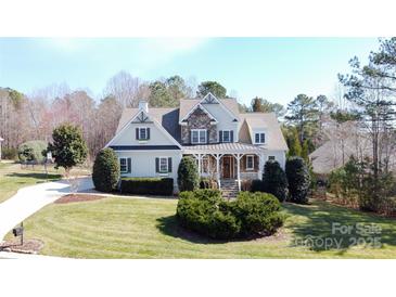 Charming two-story home with stone accents and well-manicured lawn at 152 Bay Shore Loop, Mooresville, NC 28117