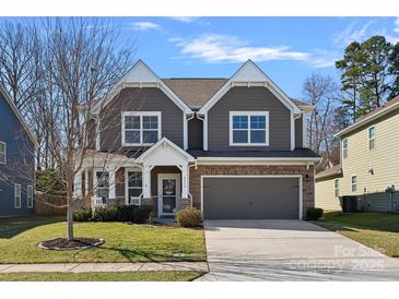 Charming two-story home with gray siding, stone accents, a two-car garage, and a well-maintained lawn at 2352 Seagull Dr, Denver, NC 28037