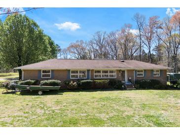 Charming single-story brick home with a well-maintained lawn and blue-shuttered windows on a sunny day at 4937 Lebanon Dr # 1, Charlotte, NC 28273