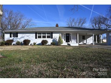 Charming one-story home featuring a well-maintained yard and a convenient carport at 7010 E Hwy 152 Hwy, Rockwell, NC 28138