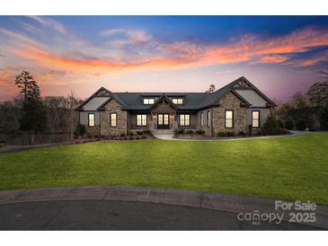 Stunning stone and siding home with manicured lawn and professionally designed landscape at 826 Misty Arbor Frd, Clover, SC 29710