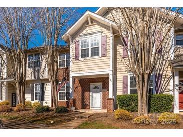 Charming two-story home with brick accents, American flag, and well-maintained landscaping at 8422 Chaceview Ct, Charlotte, NC 28269