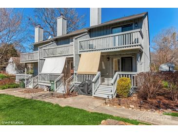 Two-story townhome featuring private balconies, covered patios, and gray siding at 100 Willow Run Dr, Gastonia, NC 28056