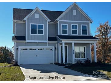 Two-story home with gray siding, a two-car garage, and a welcoming front porch at 338 Shinnville Rd, Mooresville, NC 28115