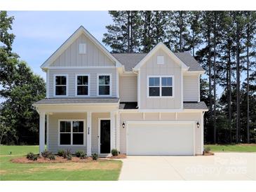 Charming two-story home featuring a two-car garage and a beautifully maintained front yard at 338 Shinnville Rd, Mooresville, NC 28115