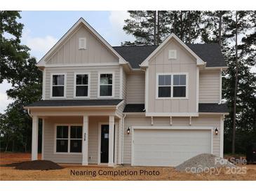 Two-story home with a two car garage, board and batten siding and a covered front porch with columns at 338 Shinnville Rd, Mooresville, NC 28115