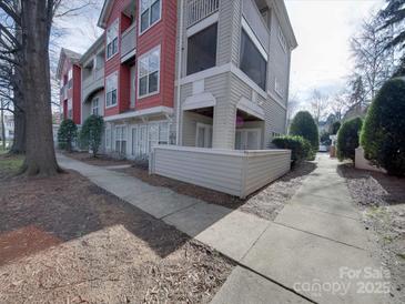 A ground-level exterior view showcasing the side of the building with a walkway at 1162 W 1St St, Charlotte, NC 28202