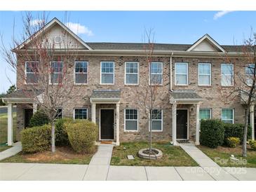 Charming brick townhome with manicured landscaping and welcoming front entrances at 1205 Skywatch Ln, Monroe, NC 28112