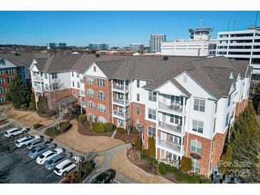 Stunning multi-story condo with brick and white siding, balconies, and parking at 14941 Santa Lucia Dr, Charlotte, NC 28277