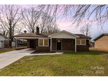 Charming brick home featuring a carport and well-maintained lawn at 209 Palmer St, Shelby, NC 28150