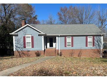 Charming single-story home featuring red shutters, a brick foundation, and a welcoming front entrance at 2234 Oak Leigh Dr, Charlotte, NC 28262