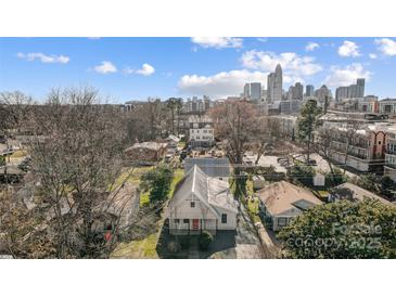 This aerial shows a lovely home with an up-close view of the Charlotte skyline in the background at 416 E 18Th St, Charlotte, NC 28206