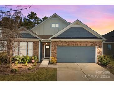Charming home featuring a stone and siding exterior, complemented by a two-car garage and manicured landscaping at 4288 Legacy Dr, Denver, NC 28037