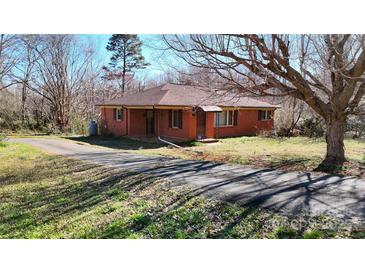 Charming one-story brick home with a well-maintained lawn and long driveway at 4774 E Nc 150 Hwy, Lincolnton, NC 28092