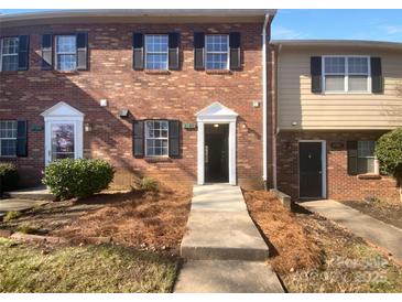Charming brick townhome featuring a well-manicured front yard and traditional architectural details at 6108 Heath Ridge Ct, Charlotte, NC 28210