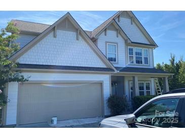 Two-story home featuring neutral paint, a two-car garage, and manicured landscaping at 7166 Dove Field Ln, Fort Mill, SC 29707