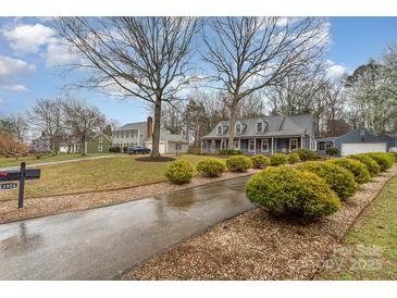 Charming home featuring a long driveway, manicured bushes, and a traditional style at 11924 Parks Farm Ln, Charlotte, NC 28277