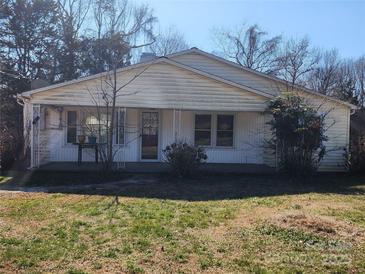 Classic single story home featuring a covered front porch and traditional siding, set against a backdrop of mature trees at 1222 Sparrow Springs Rd, Kings Mountain, NC 28086