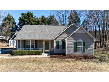Charming single-story home with a welcoming front porch and well-maintained landscaping, situated in a serene neighborhood at 3507 Sassafras Trl, Waxhaw, NC 28173