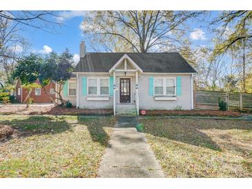 Charming cottage-style home with unique blue shutters and a well-maintained front yard at 3800 Craig Ave, Charlotte, NC 28211