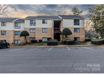 Attractive condo building with well-maintained landscaping and ample parking at 4814 Spring Lake E Dr, Charlotte, NC 28212