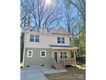 Charming two-story home featuring a cozy front porch, neutral siding, and well-manicured front yard at 613 Granite Ave, Gastonia, NC 28052