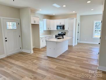 Open kitchen with white cabinetry and stainless steel appliances at 620 Granite Ave, Gastonia, NC 28052