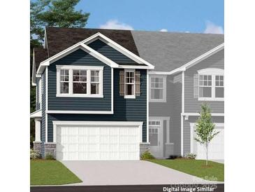 New two story home with a two car garage, dark siding, and a well manicured front lawn at 7216 Hodges Meadow Ln, Charlotte, NC 28213