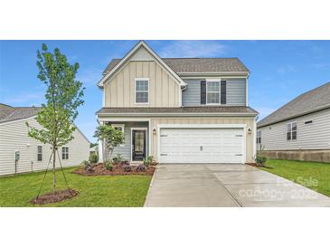 Charming two-story home with a well-manicured lawn and attached two-car garage at 8421 Norman Forest Rd, Lancaster, SC 29720
