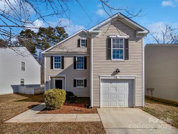 Charming home with a one-car garage and neutral siding under a bright, blue sky at 1121 Swearngan Ridge Ct, Charlotte, NC 28216