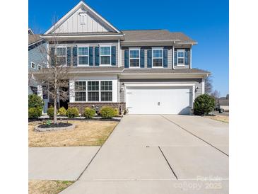 Charming two-story home with gray siding, blue shutters, and a well-maintained front yard at 126 W Morehouse Ave, Mooresville, NC 28117