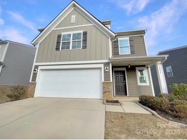Charming two-story home featuring a two-car garage, neutral siding, and well-maintained landscaping at 1298 Bryson Ln, Denver, NC 28037