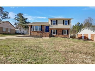 Charming two-story home with brick and siding exterior, featuring a well-maintained lawn and inviting entryway at 8103 Idlewild Rd, Indian Trail, NC 28079