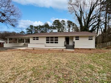 Charming single-story home with a carport, painted white exterior and a well-manicured front yard at 924 Springdale Ln, Gastonia, NC 28052