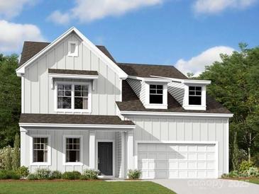 Charming two-story home featuring board and batten siding, dormer windows and an attached two car garage at 11035 Lochmere Rd, Charlotte, NC 28278
