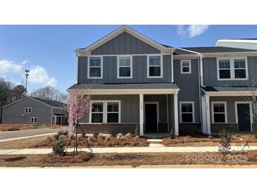 Charming new construction townhome with gray siding and covered front porch, ready for move-in at 114 Ciara Pl # A, Mooresville, NC 28117