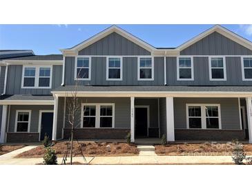 Charming two-story townhome with gray siding, white trim, and a welcoming front porch at 114 Ciara Pl # C, Mooresville, NC 28117