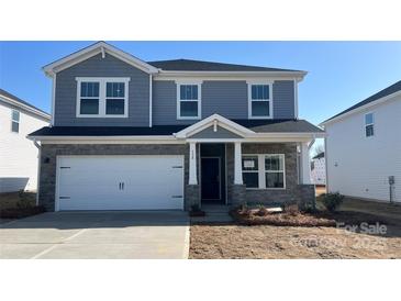 Charming two-story home with a stone facade, a two-car garage, and classic architectural details at 138 Aberdeen Dr, Salisbury, NC 28144