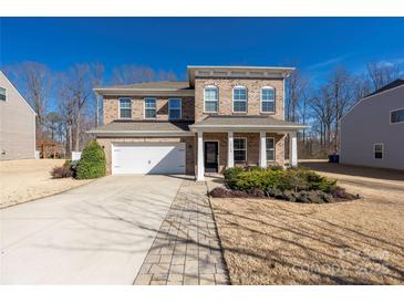 Charming two-story brick home with attached garage and inviting front porch at 16110 Foreleigh Rd, Huntersville, NC 28078