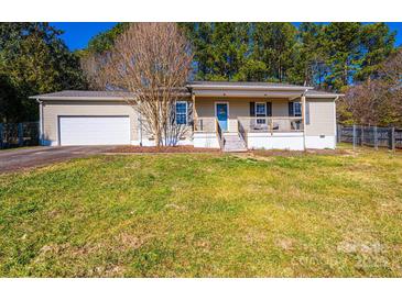 Charming single-story home featuring a front porch, attached garage, and a well-maintained lawn at 3415 23Rd Ne St, Hickory, NC 28601